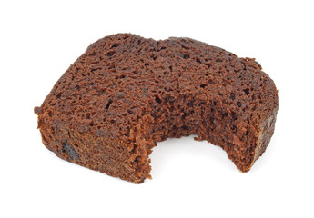 Single slice of chocolate cake that has been bitten