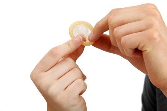 young couple with a condom (white background))