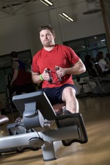 Fototapeta na wymiar Man Working Out In A Gym