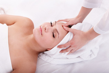 Obraz na płótnie Canvas Young woman in spa. Facial massage.