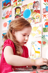 Child  playing with clay in play room.