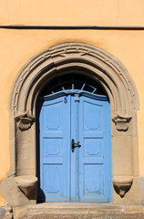 old blue door and orange wall