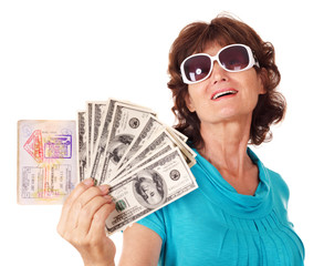 Senior woman holding passport and money. Isolated.