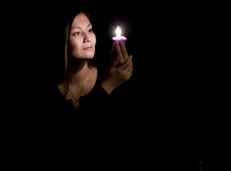 Portrait of yoing woman with candle