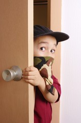 kid sneaking through door