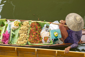 old woman selling fruit in floating market