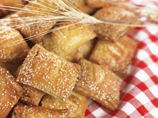 small sesame cheese pies(sousaminia) with wheat on a napkin