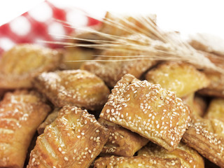 small sesame cheese pies(sousaminia) with wheat on a red-and-whi