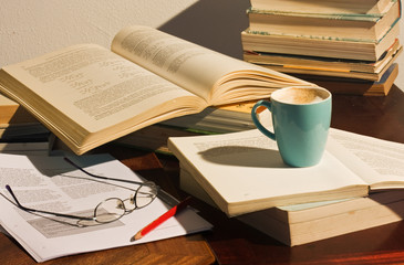 Study desk with books and glasses
