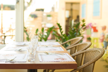 Tableware on table with series chairs.
