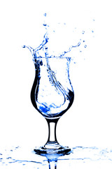 Pure water splashing into glass isolated on white