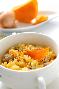 Pumpkin risotto decorated with piece of a baked pumpkin