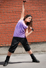 Beautiful teenage girl dancing hip-hop