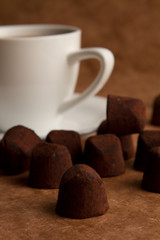 cup of coffee with cinnamon on a old paper background.