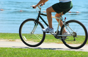 Woman riding a bike at the park by the lake