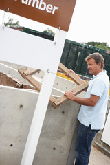 Man At Recycling Centre Recycling Timber