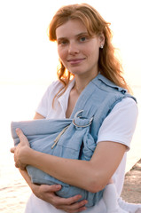 young mother with her baby in sling