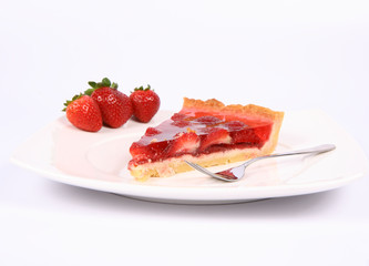 Piece of Strawberry Tart on a plate decorated with strawberries