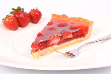 Piece of Strawberry Tart on a plate decorated with strawberries