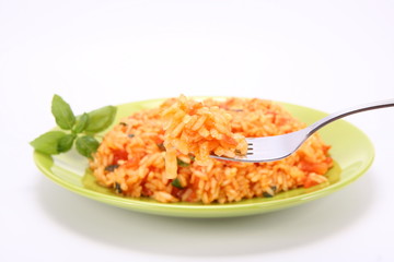 Risotto with tomatoes with basil - some of it on a fork
