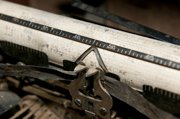 Print roll and tape of a dusty old typewriter.