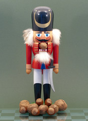 Wooden Nutcracker with Nuts Isolated on a Green Background.