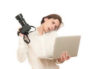 professional photographer holds camera and laptop while calling