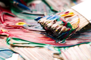 Brush mixing paint on palette