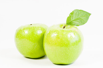 two green apples with leaf
