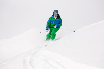 Fototapeta na wymiar Man skiing downhill