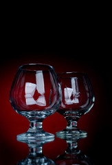 close up cognac glass on a red