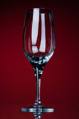 empty vine glass on a red bg