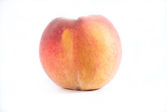 Single fresh peach on a white isolated background