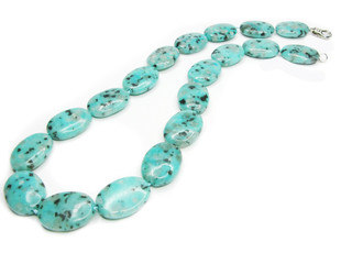 green and black spotted colored beads