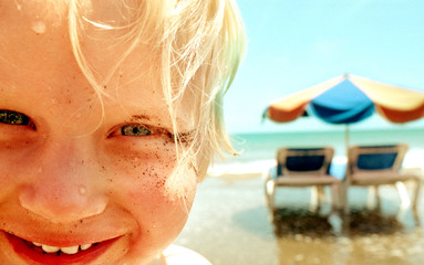 Kinder am Strand mit Sonnenschirm