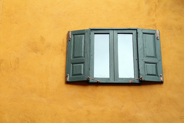green windows on orange wall
