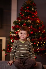 Little boy in front of christmas tree
