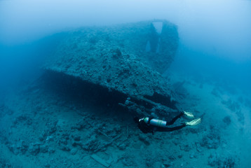 Female scuba diver exploring ship wreck