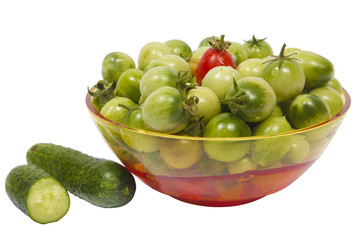 A bowl of green tomatoes, on a white background