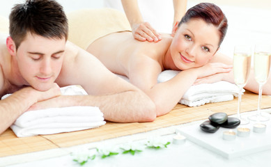 Obraz na płótnie Canvas Attractive caucasian couple receiving a back massage