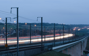 Fototapeta premium Motorway and train bridge at dusk