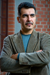 Fototapeta premium Portrait of a confident handsome man with arms crossed