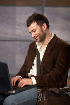 Smiling guy with laptop