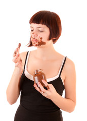 Young beautiful glutton eat chocolate isolated on white