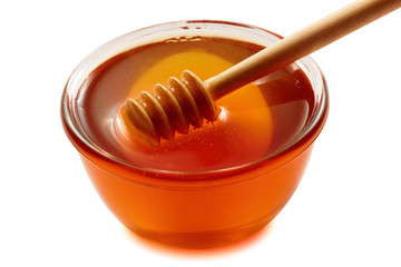 Wooden dipper with bowl of honey.