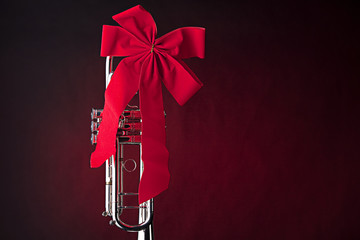 Silver Trumpet with Red Bow on Red