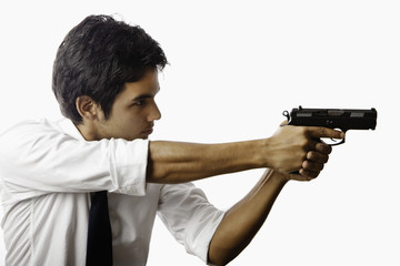 Fototapeta na wymiar young asian man with automatic pistol