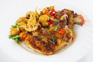 Grilled pork loin chop on white plate