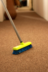 Plastic broom on carpet