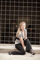 Young woman sitting by an abstract background